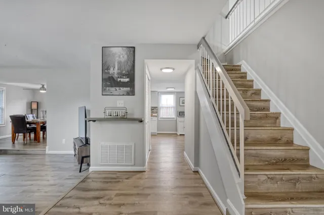 a view of entryway and hall with wooden floor