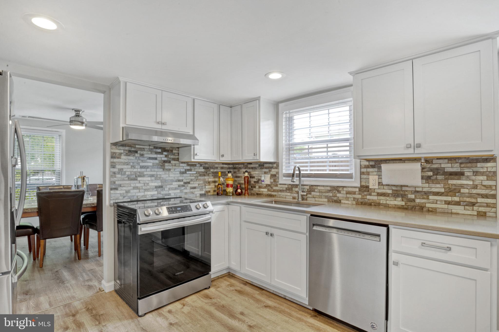 103 Cherry Tree Court Sterling, VA 20164 - Photo 9 of 32 a kitchen with stainless steel appliances granite countertop a stove top oven a sink dishwasher and a refrigerator