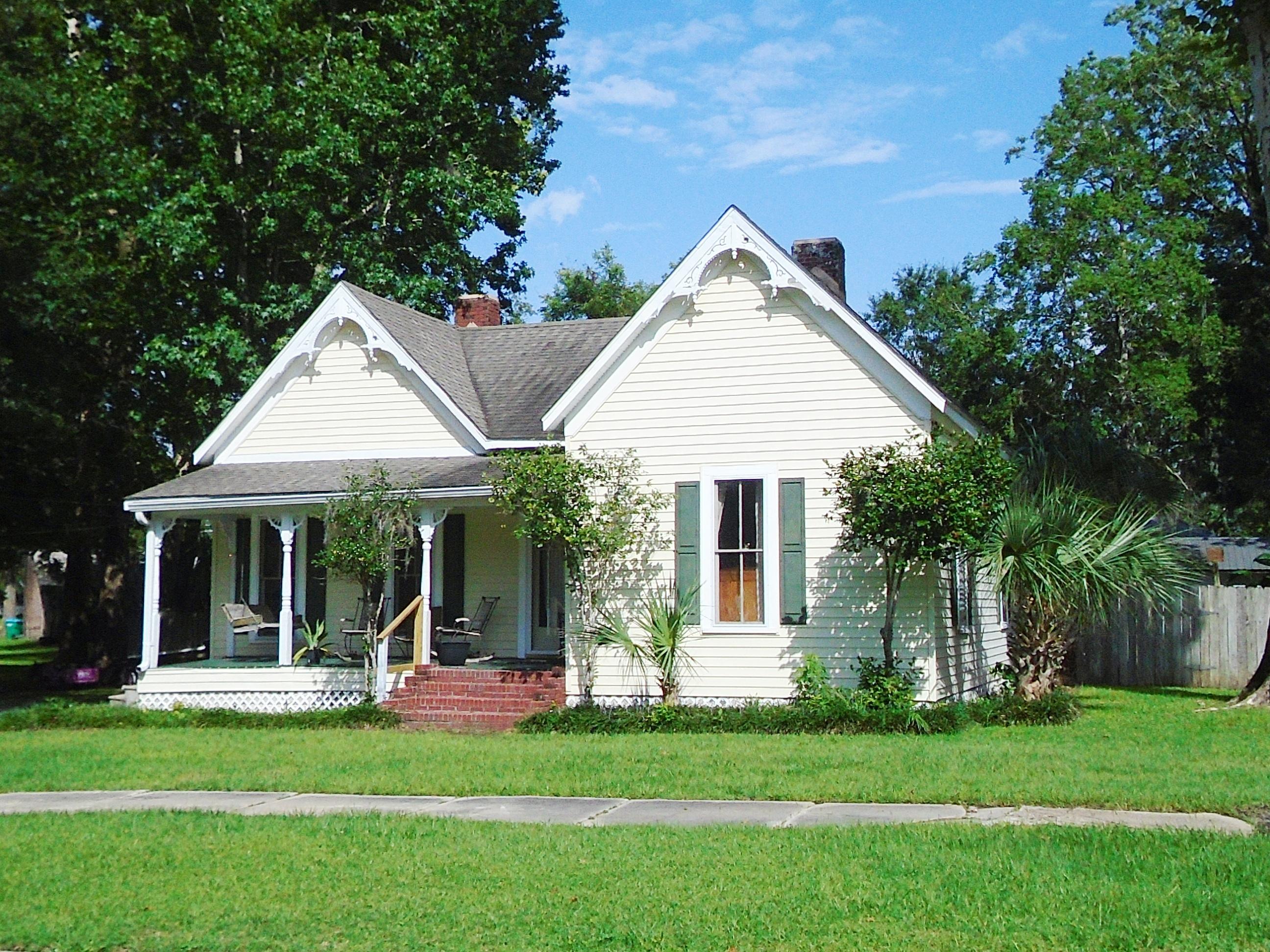 910 5th Street Florala, AL 36442 - Photo 1 of 34 a front view of a house with a garden and porch