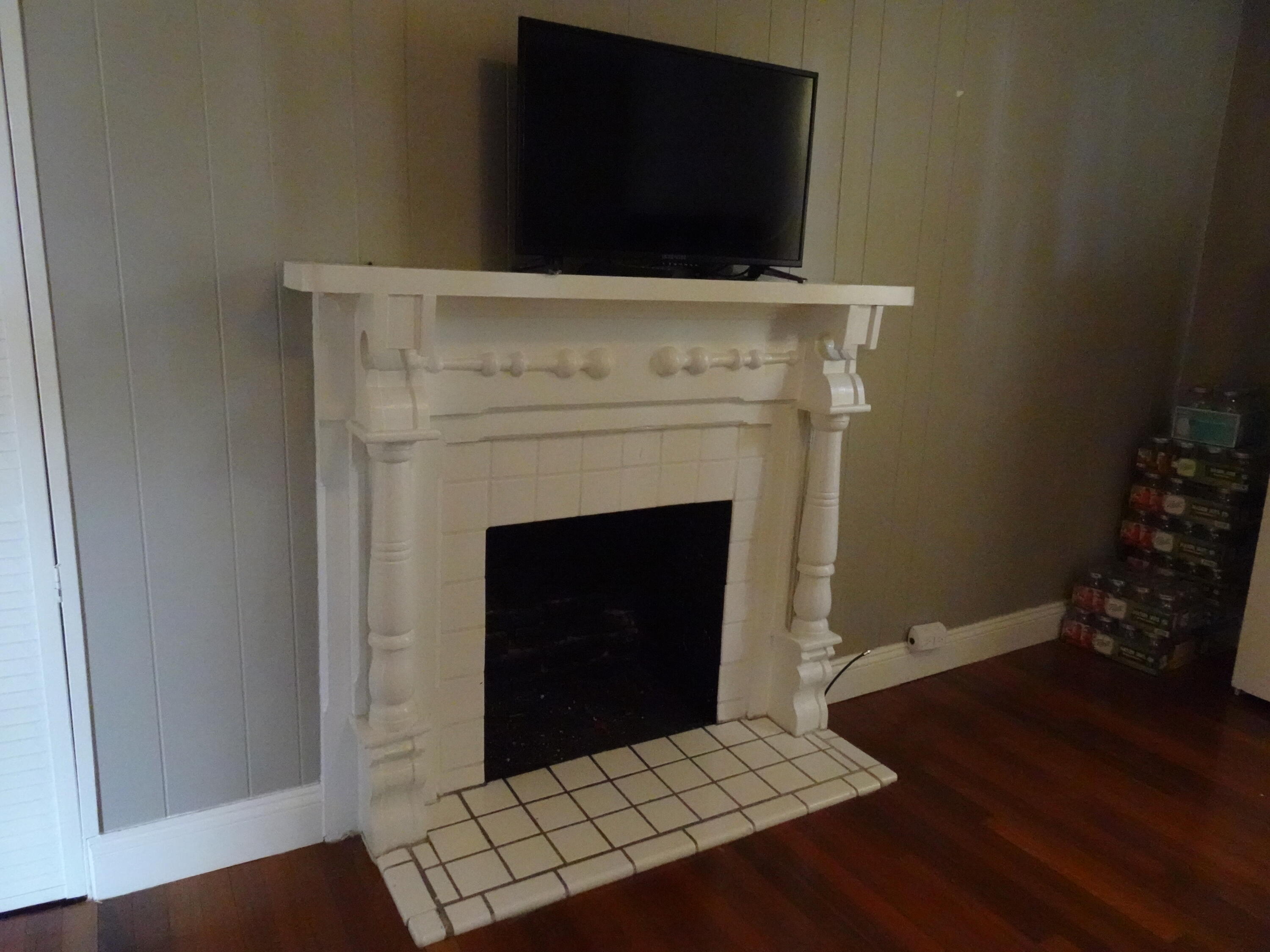910 5th Street Florala, AL 36442 - Photo 15 of 34 a living room with a fireplace and wooden floor