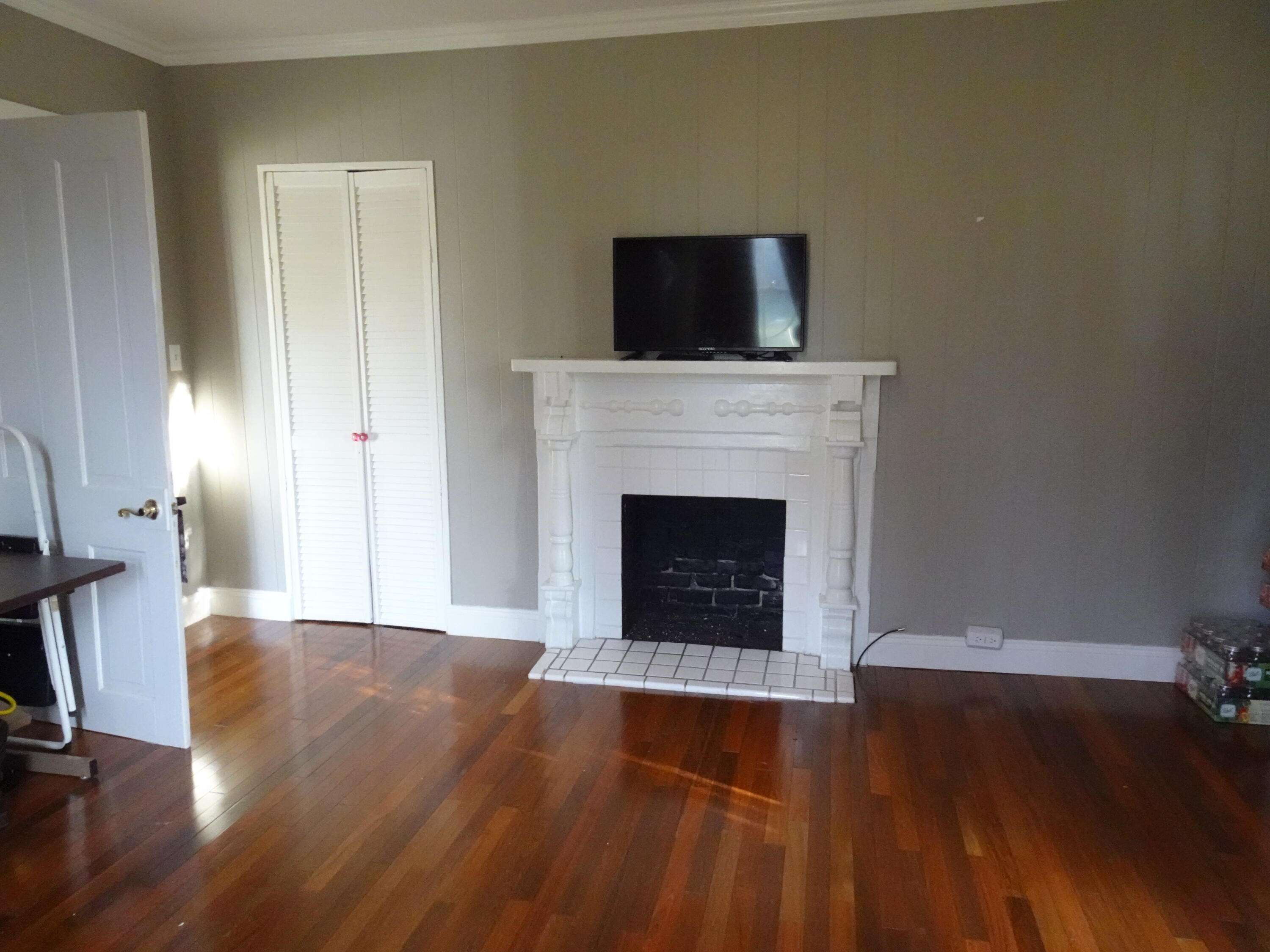 910 5th Street Florala, AL 36442 - Photo 18 of 34 a living room with a fireplace and wooden floor