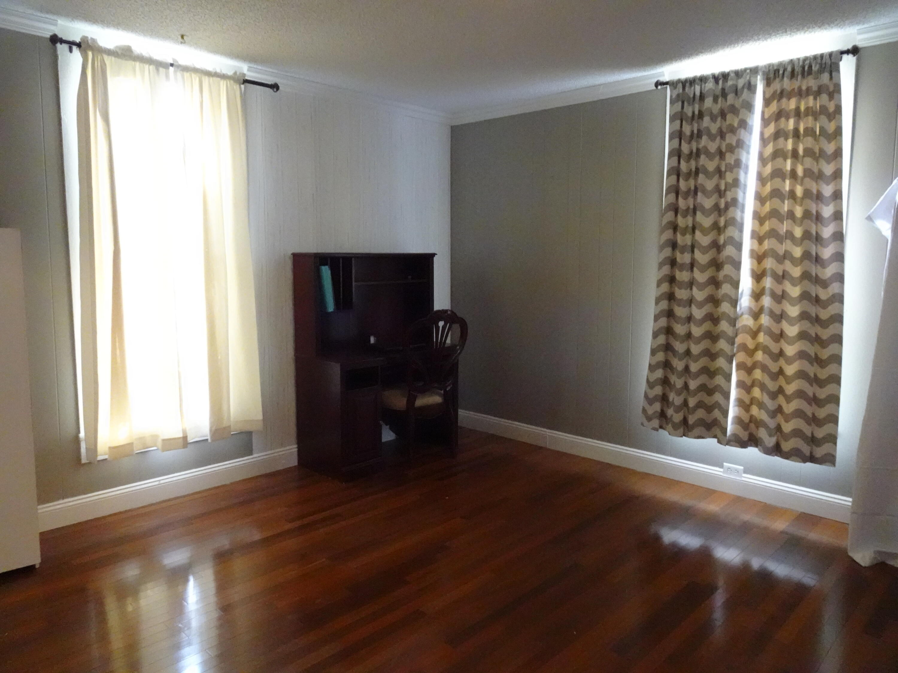 910 5th Street Florala, AL 36442 - Photo 22 of 34 a view of an empty room with a window and wooden floor