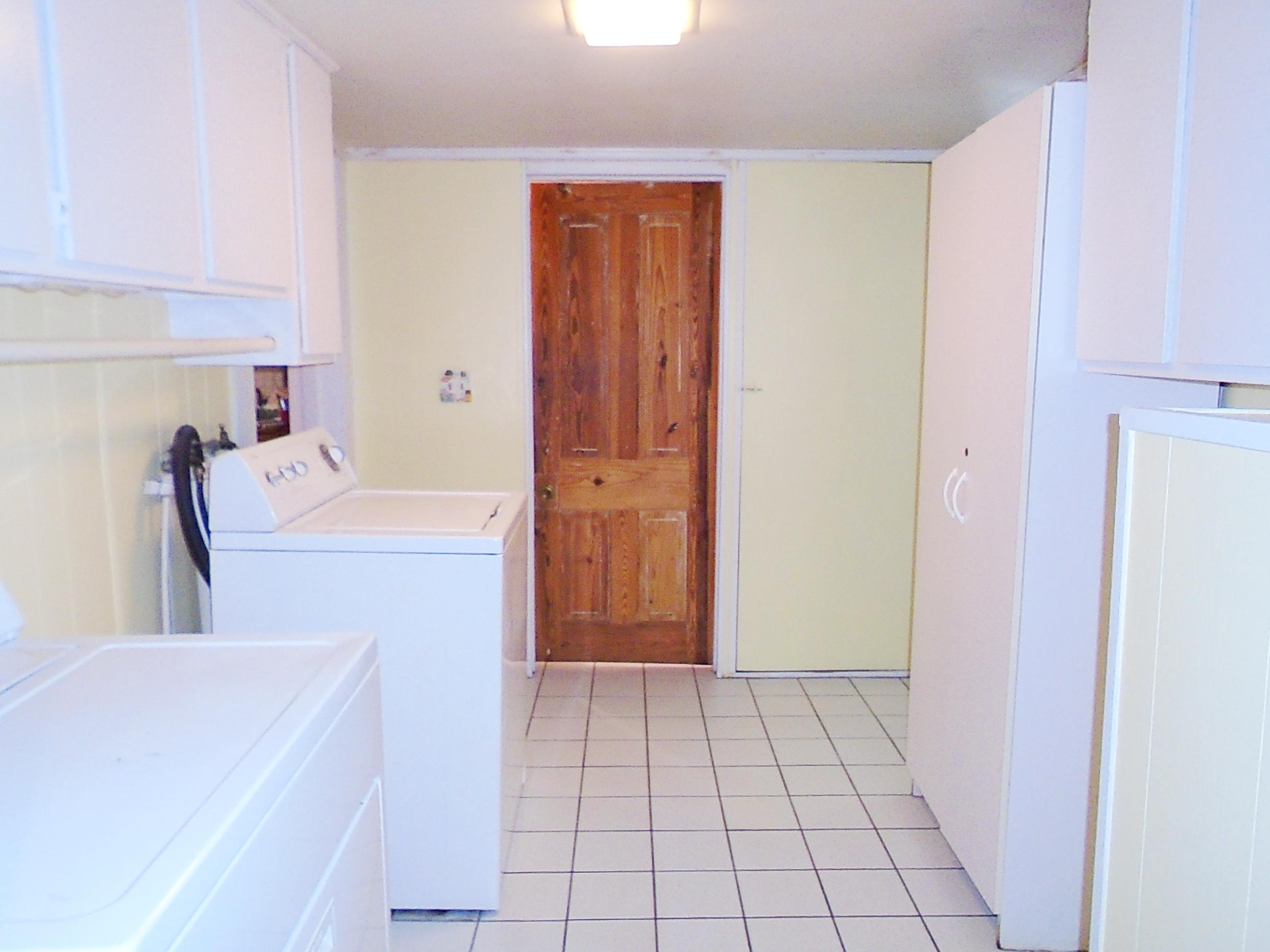 910 5th Street Florala, AL 36442 - Photo 25 of 34 a utility room with cabinets washer and dryer