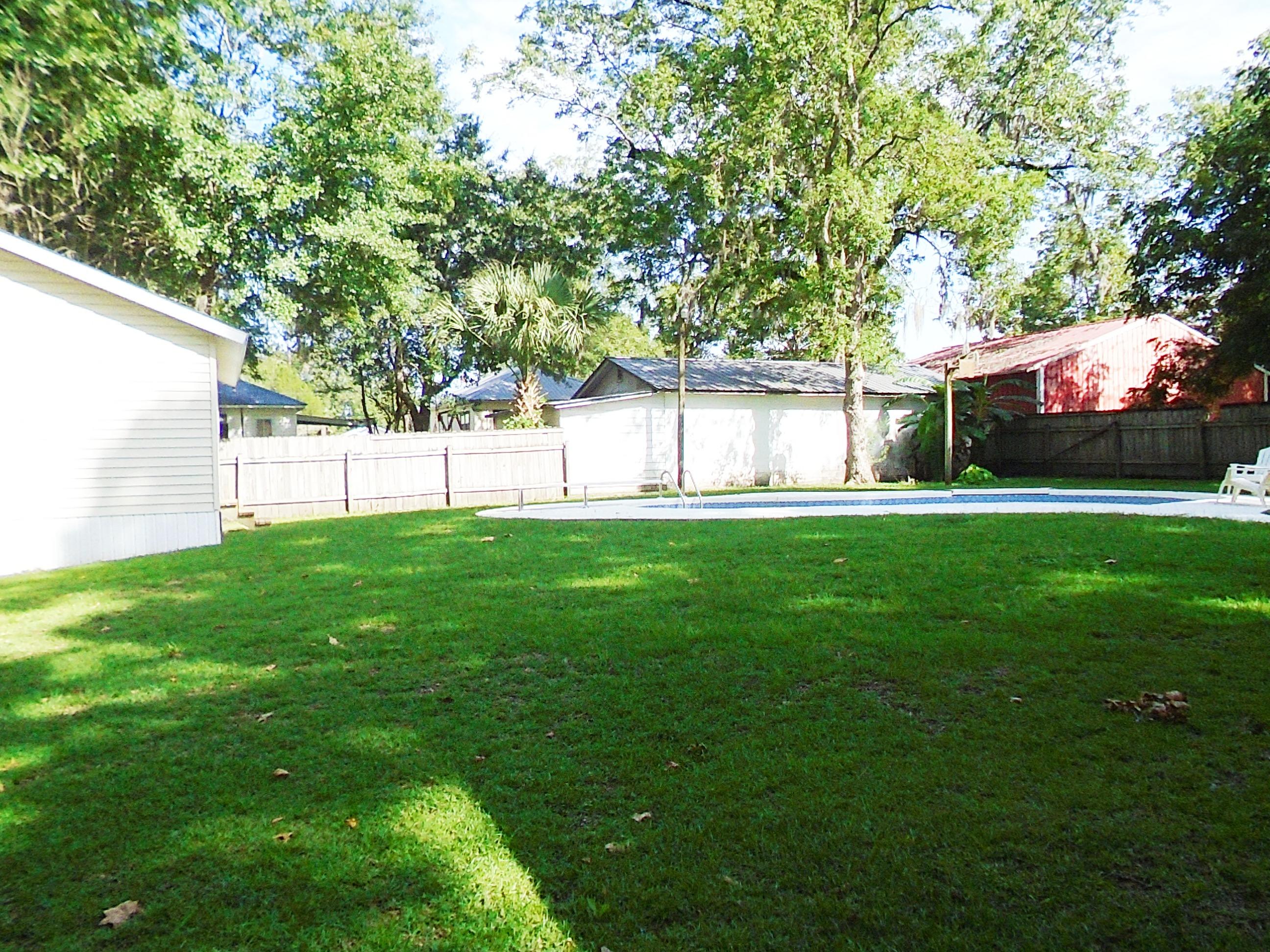 910 5th Street Florala, AL 36442 - Photo 3 of 34 a view of a backyard with large trees