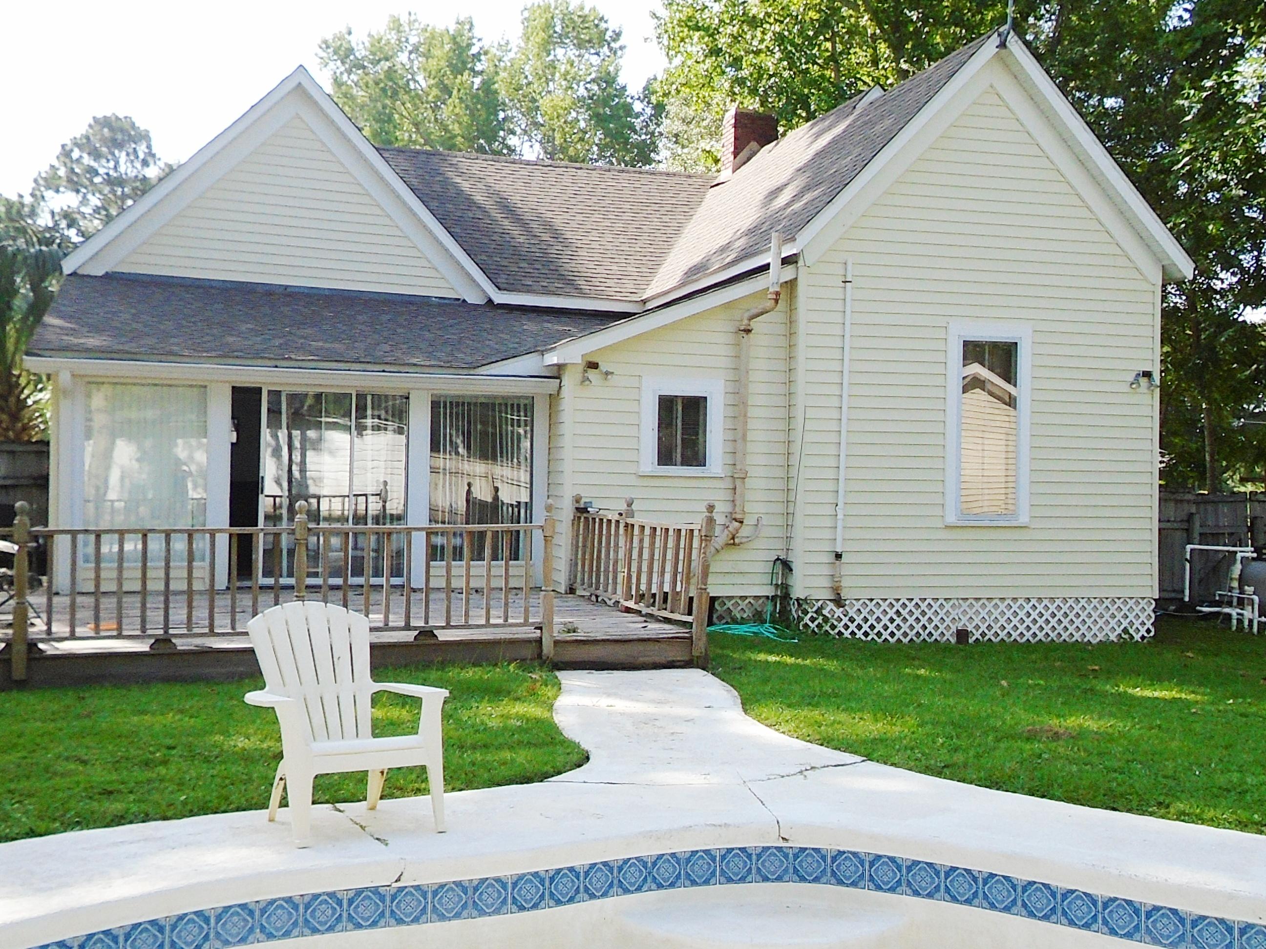 910 5th Street Florala, AL 36442 - Photo 4 of 34 a view of a house with a yard and lawn chairs with plants