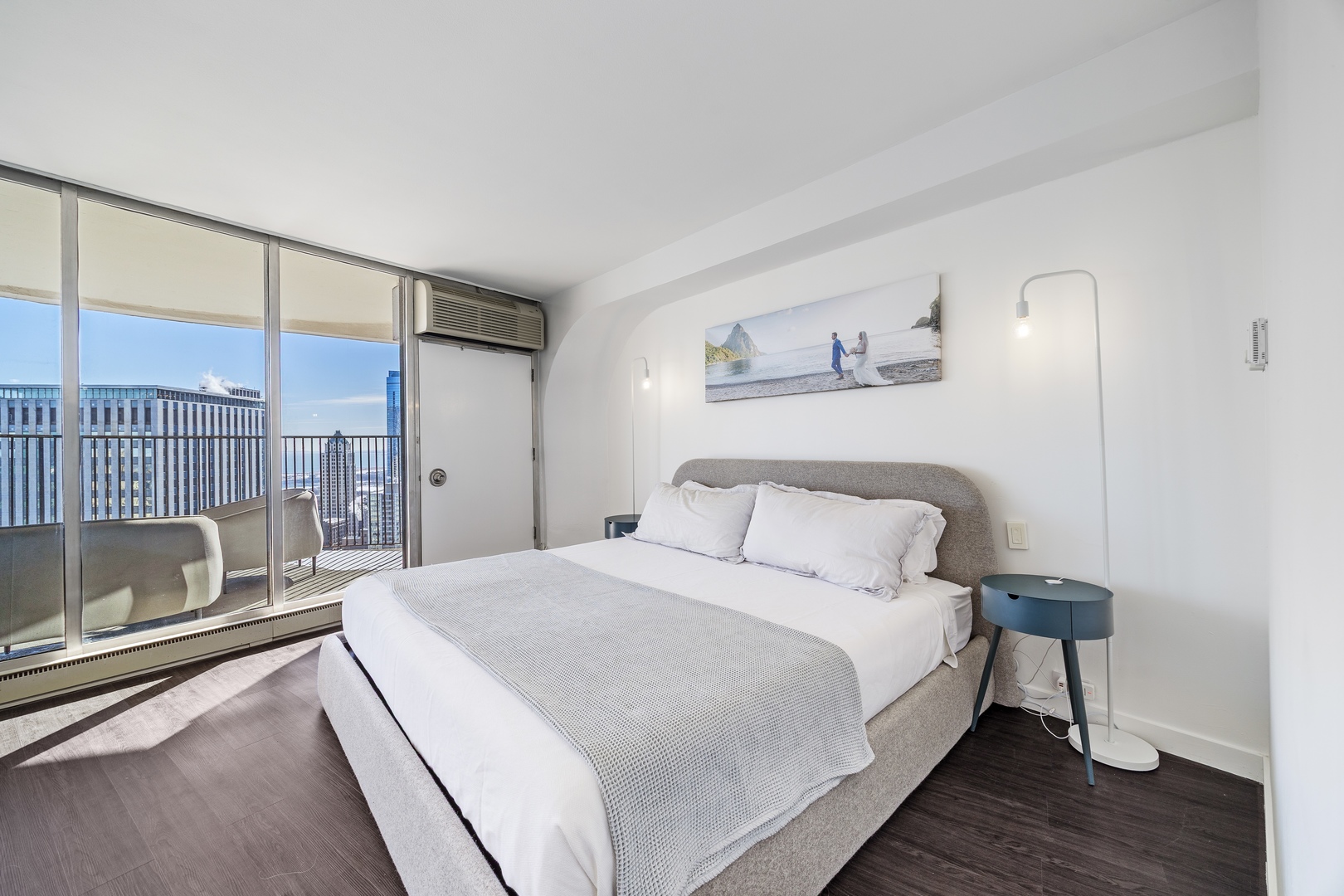 300 North State Street, Unit 5506 Chicago, IL 60654 - Photo 12 of 28 a bedroom with a bed and a view of walk in closet with wooden floor