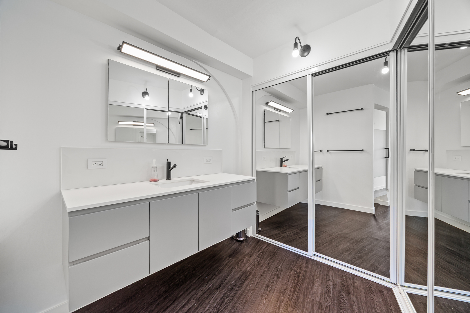 300 North State Street, Unit 5506 Chicago, IL 60654 - Photo 13 of 28 a spacious bathroom with a shower sink and mirror