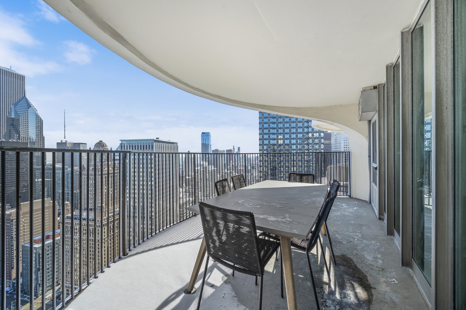 300 North State Street, Unit 5506 Chicago, IL 60654 - Photo 20 of 28 a view of a balcony dining table and chairs