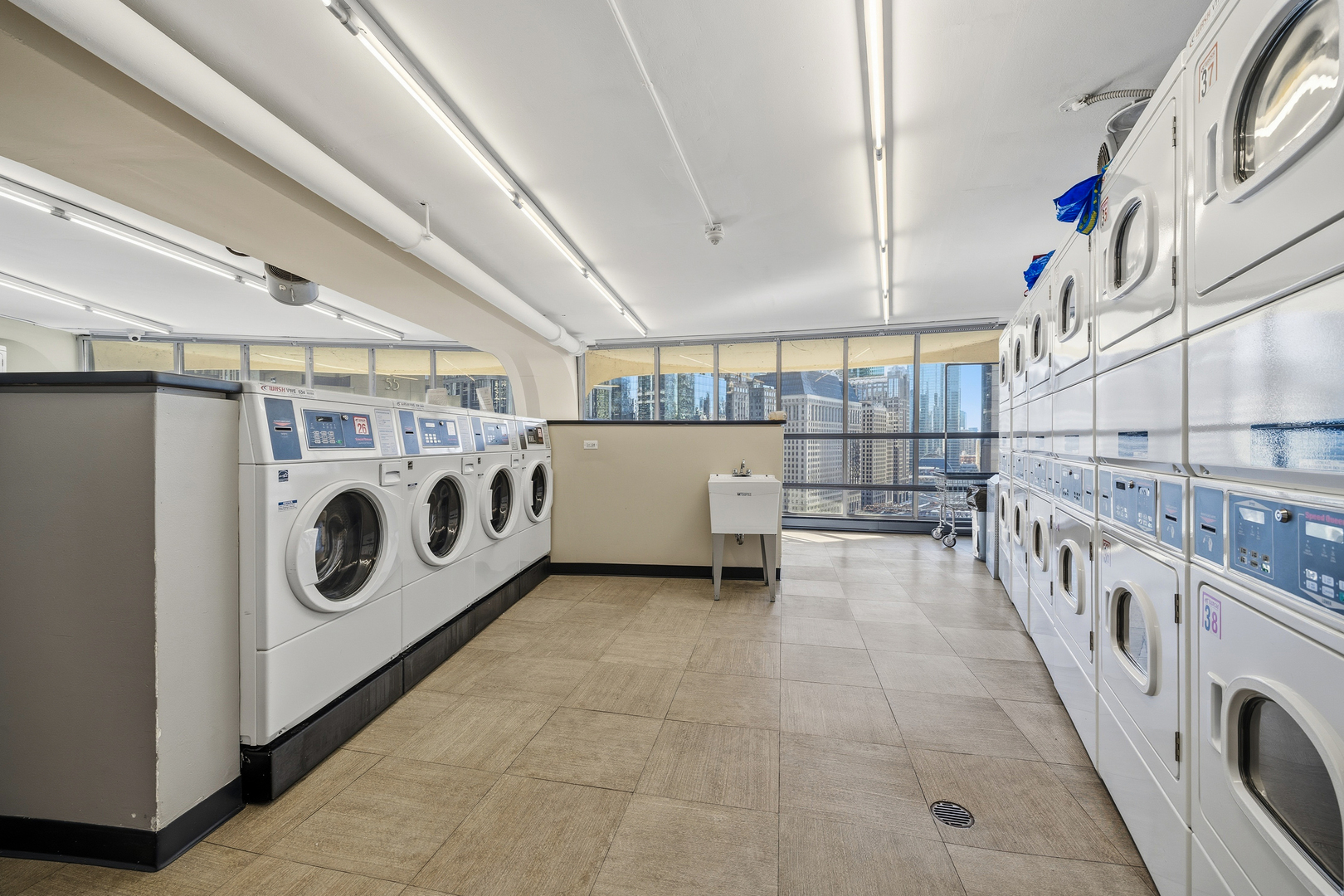 300 North State Street, Unit 5506 Chicago, IL 60654 - Photo 27 of 28 a utility room with multiple dryer and washer
