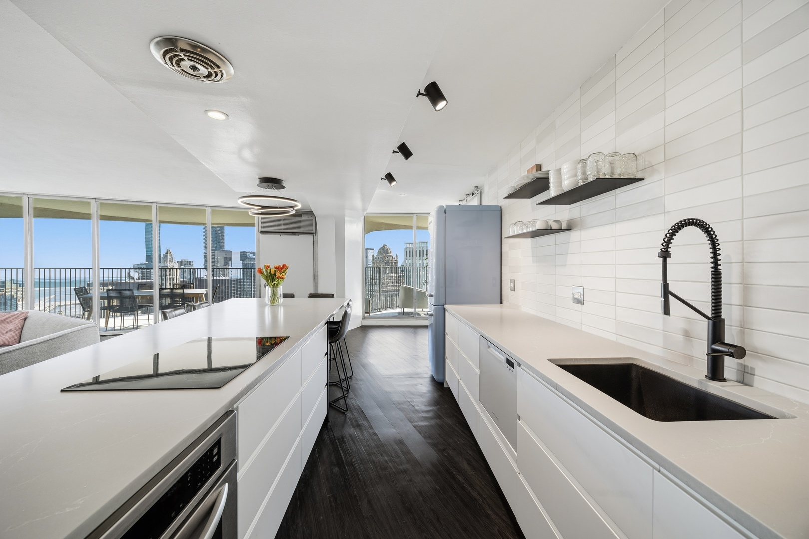 300 North State Street, Unit 5506 Chicago, IL 60654 - Photo 10 of 28 a large white kitchen with a large window and stainless steel appliances