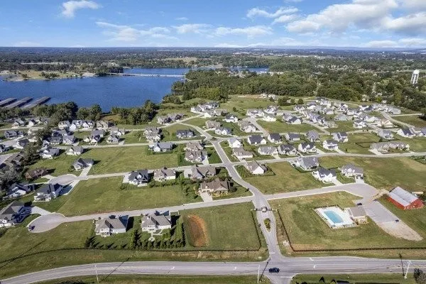 an aerial view of a city with lots of residential buildings and mountain view in back