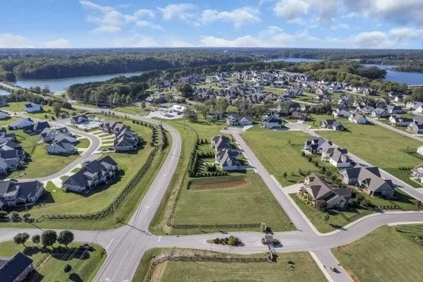 an aerial view of a pool with a yard