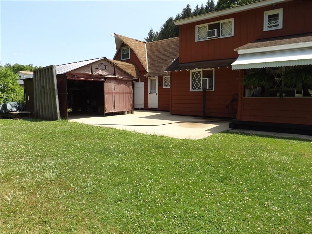 1641 Dime Road Vandergrift, PA 15690 - Photo 21 of 23 a front view of a house with a garden and yard