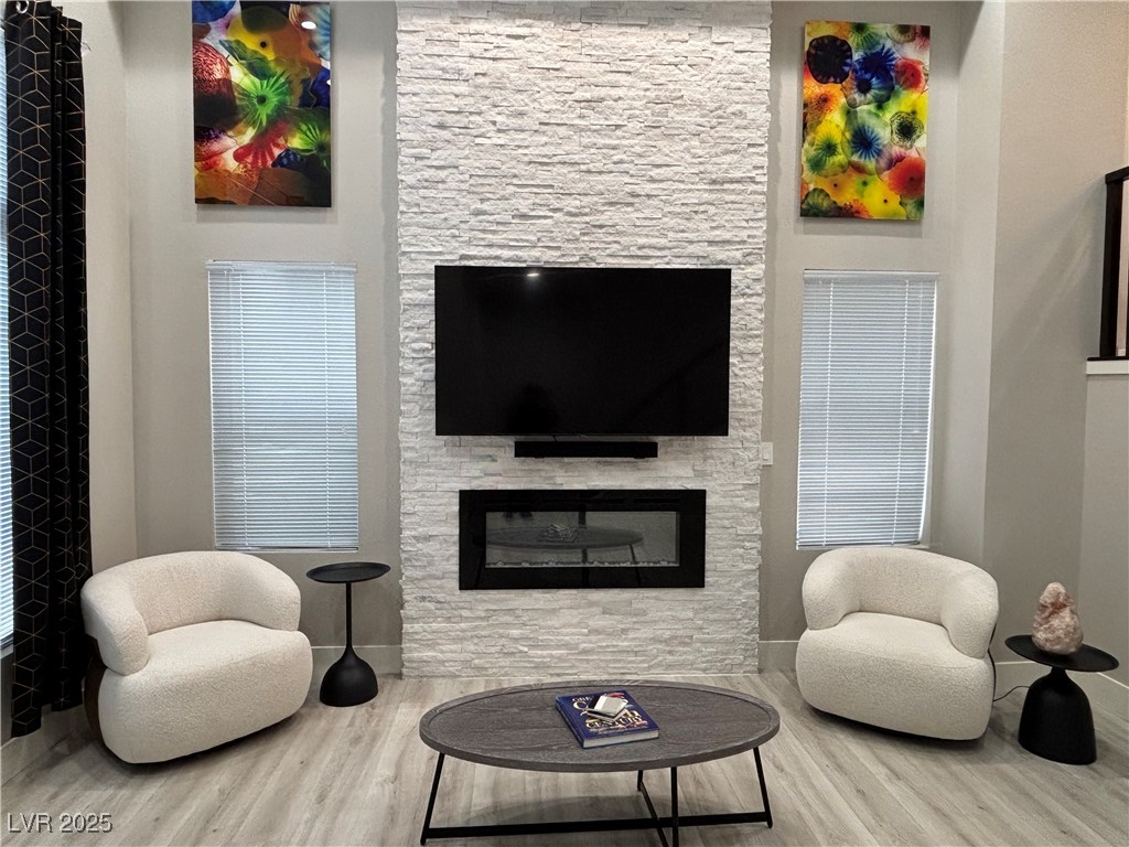 2784 Fountain Ridge Lane Henderson, NV 89074 - Photo 16 of 37 Living area featuring wood finished floors and a fireplace