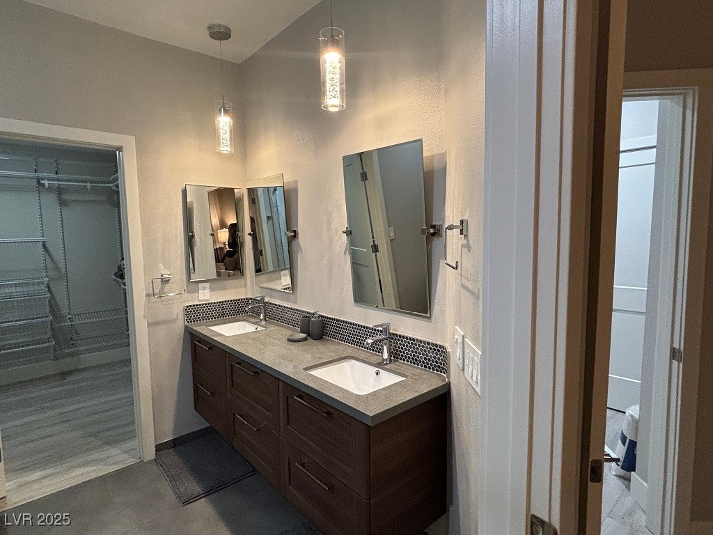 2784 Fountain Ridge Lane Henderson, NV 89074 - Photo 20 of 37 Full bathroom featuring double vanity and a walk in closet