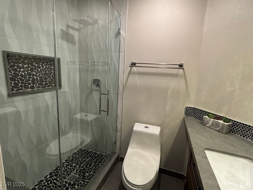 2784 Fountain Ridge Lane Henderson, NV 89074 - Photo 22 of 37 Full bath featuring a stall shower, vanity, and a textured wall