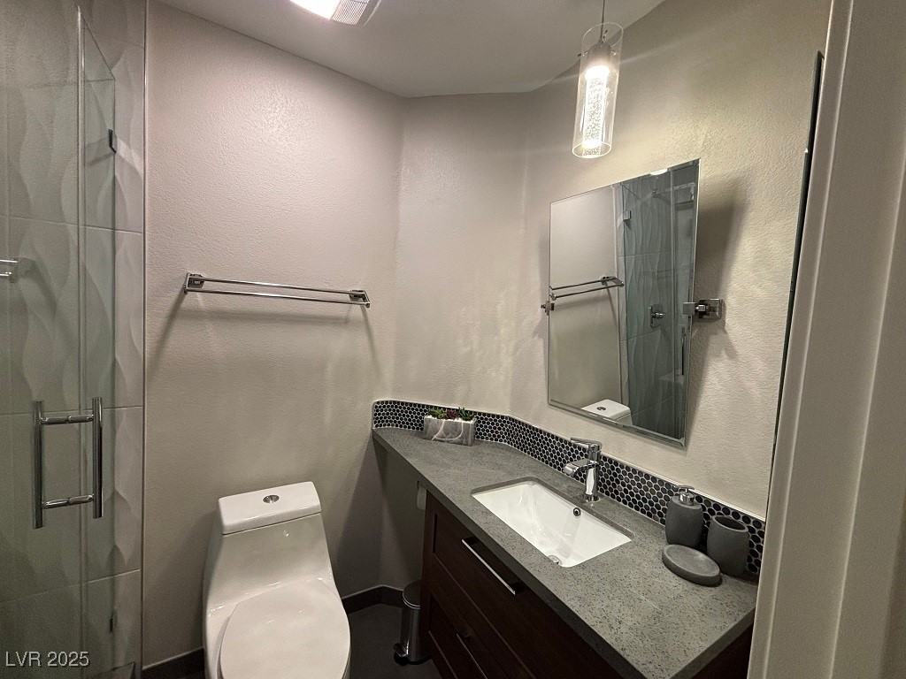 2784 Fountain Ridge Lane Henderson, NV 89074 - Photo 23 of 37 Bathroom featuring vanity, a textured wall, and a shower stall