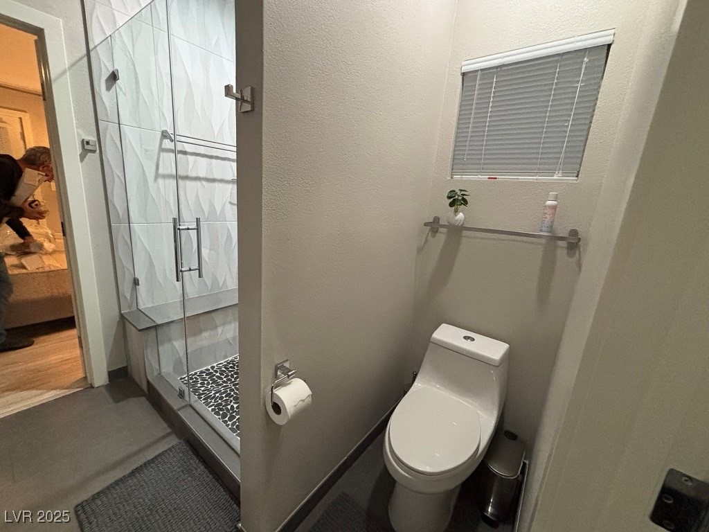 2784 Fountain Ridge Lane Henderson, NV 89074 - Photo 25 of 37 Bathroom with a stall shower and a textured wall