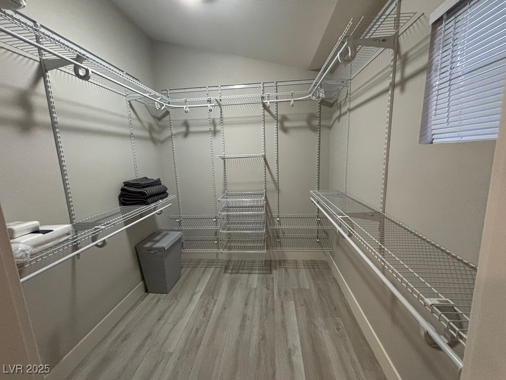 2784 Fountain Ridge Lane Henderson, NV 89074 - Photo 26 of 37 Walk in closet featuring light wood finished floors and vaulted ceiling