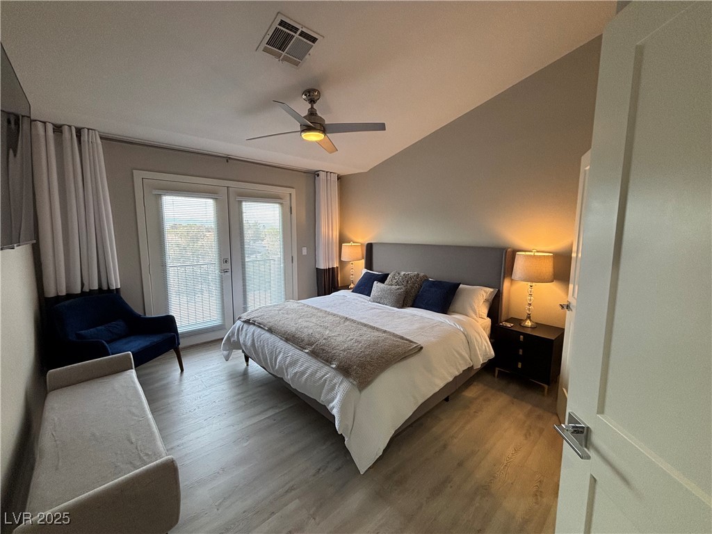 2784 Fountain Ridge Lane Henderson, NV 89074 - Photo 28 of 37 Bedroom with wood finished floors, access to exterior, a ceiling fan, lofted ceiling, and french doors