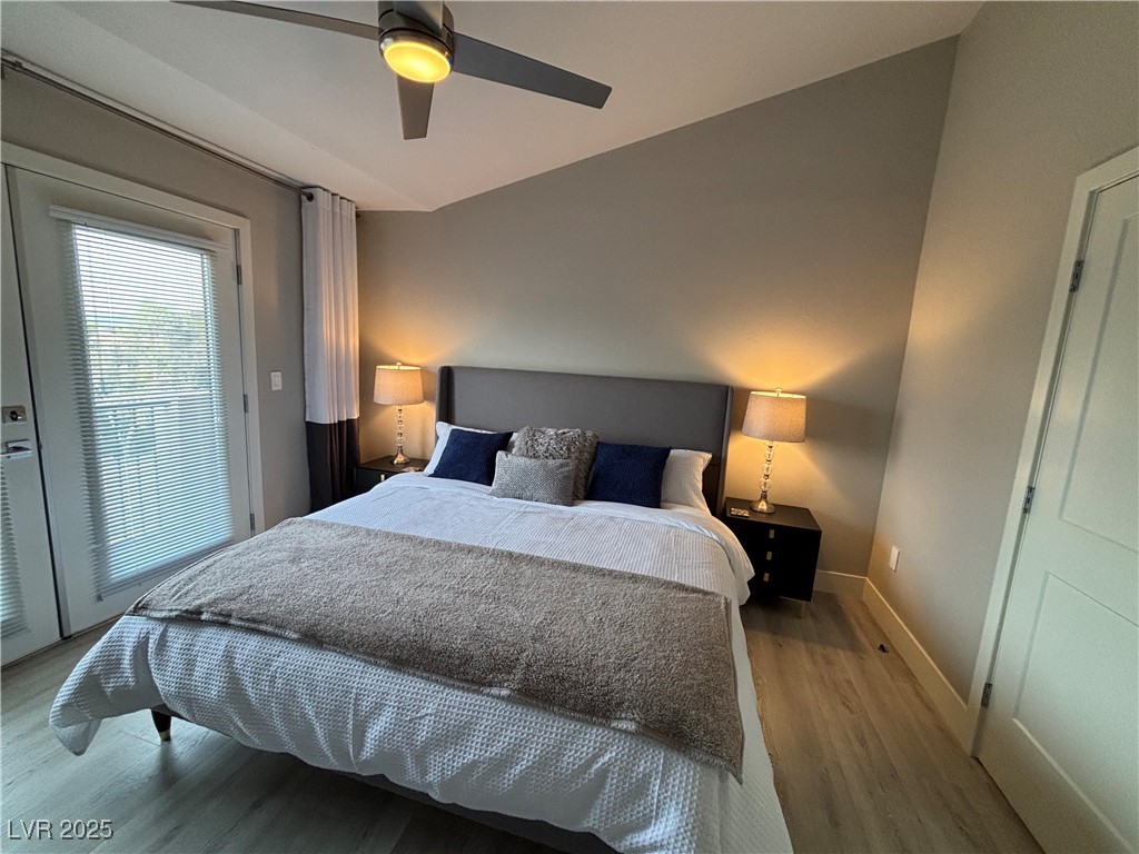 2784 Fountain Ridge Lane Henderson, NV 89074 - Photo 30 of 37 Bedroom featuring access to exterior, wood finished floors, a ceiling fan, and lofted ceiling