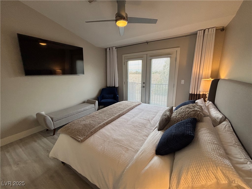 2784 Fountain Ridge Lane Henderson, NV 89074 - Photo 31 of 37 Bedroom featuring wood finished floors, access to outside, ceiling fan, vaulted ceiling, and french doors
