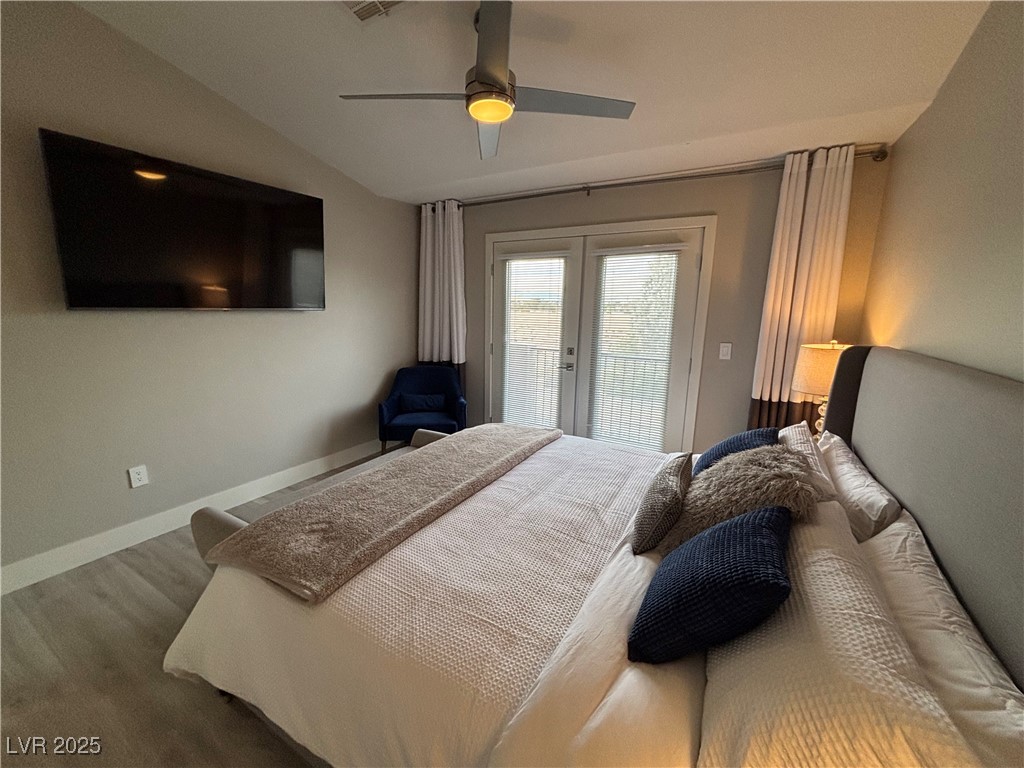2784 Fountain Ridge Lane Henderson, NV 89074 - Photo 33 of 37 Bedroom featuring french doors, wood finished floors, access to exterior, a ceiling fan, and vaulted ceiling