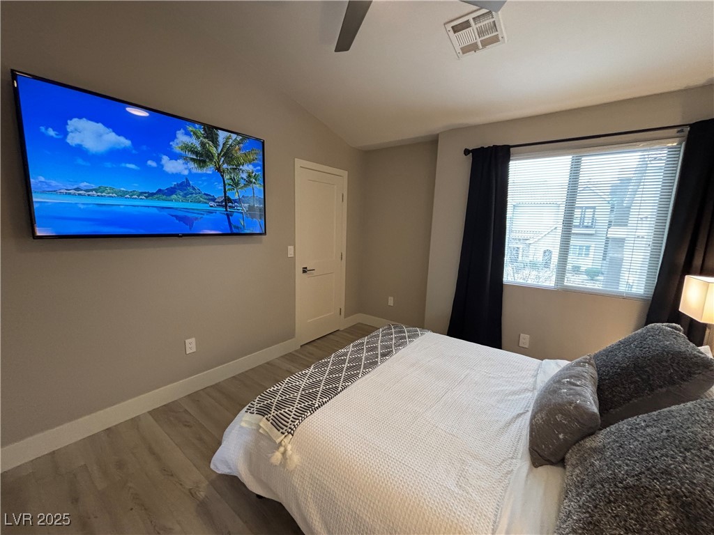 2784 Fountain Ridge Lane Henderson, NV 89074 - Photo 36 of 37 Bedroom featuring lofted ceiling, wood finished floors, and ceiling fan