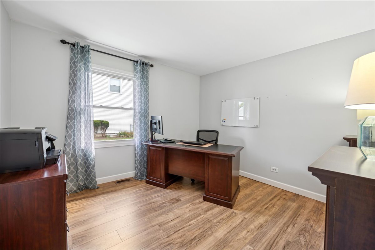 305 Pearl Street Cary, IL 60013 - Photo 12 of 25 a workspace with furniture and wooden floor