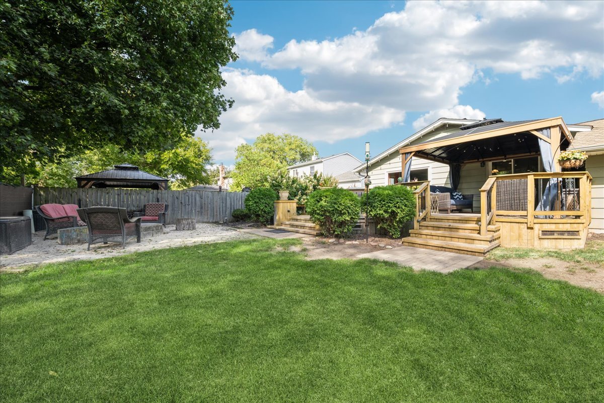 305 Pearl Street Cary, IL 60013 - Photo 19 of 25 a backyard of a house with table and chairs