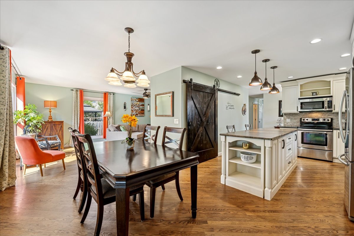 305 Pearl Street Cary, IL 60013 - Photo 5 of 25 a kitchen with stainless steel appliances kitchen island granite countertop a table chairs and a refrigerator