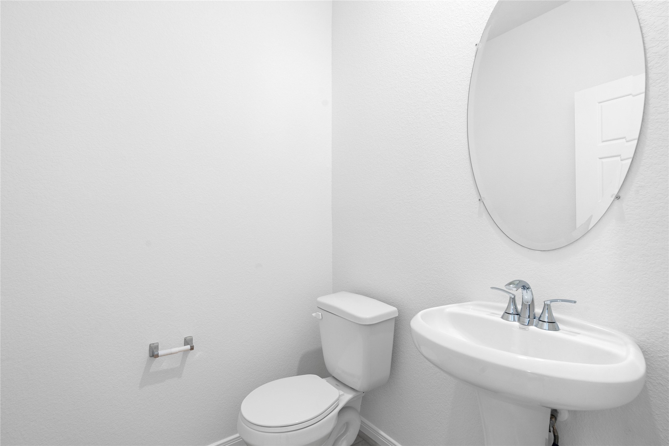 6406 Canby Court Rosharon, TX 77583 - Photo 10 of 28 The powder room on the first floor includes a pedestal sink, oval mirror, and toilet to conveniently meet your needs.