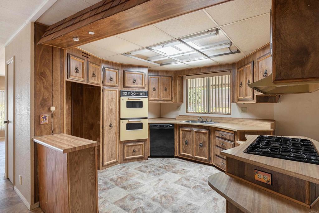 1175 La Moree Road, Unit 10 San Marcos, CA 92078 - Photo 13 of 40 a kitchen with stainless steel appliances granite countertop a stove a sink and a refrigerator