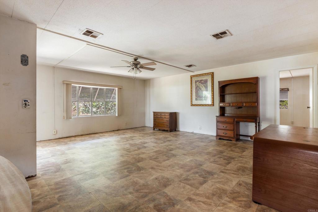 1175 La Moree Road, Unit 10 San Marcos, CA 92078 - Photo 16 of 40 a view of an empty room with a window and wooden floor