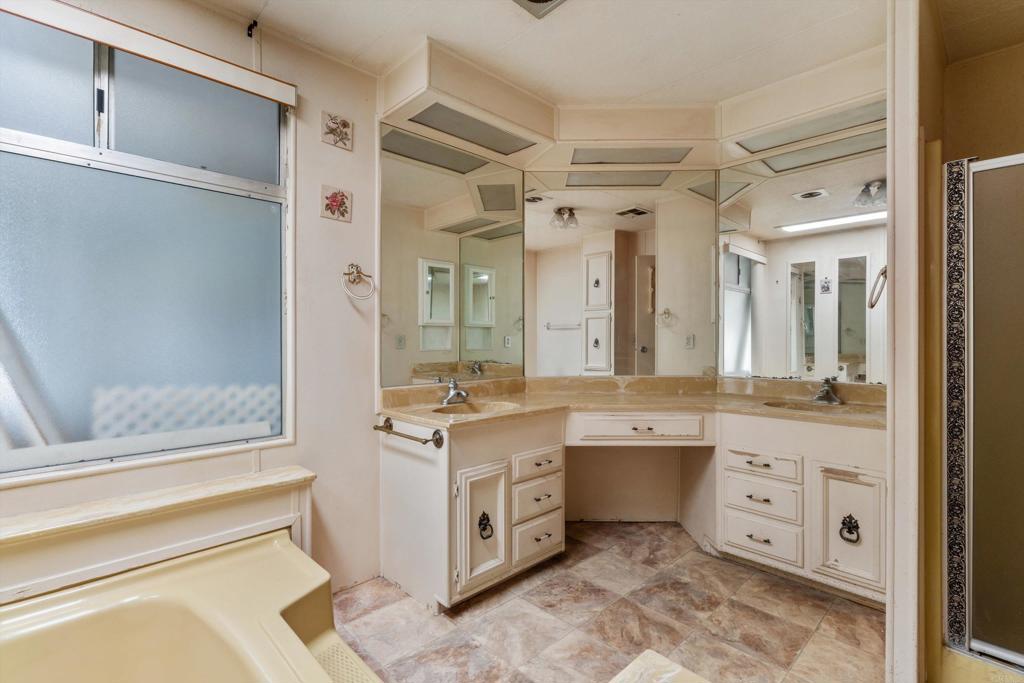 1175 La Moree Road, Unit 10 San Marcos, CA 92078 - Photo 22 of 40 a spacious bathroom with a granite countertop sink mirror and double