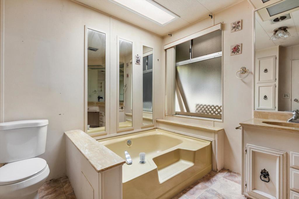1175 La Moree Road, Unit 10 San Marcos, CA 92078 - Photo 23 of 40 a bathroom with a granite countertop sink and a mirror