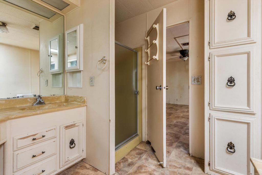 1175 La Moree Road, Unit 10 San Marcos, CA 92078 - Photo 24 of 40 view of a bathroom with a granite countertop sink mirror and shower