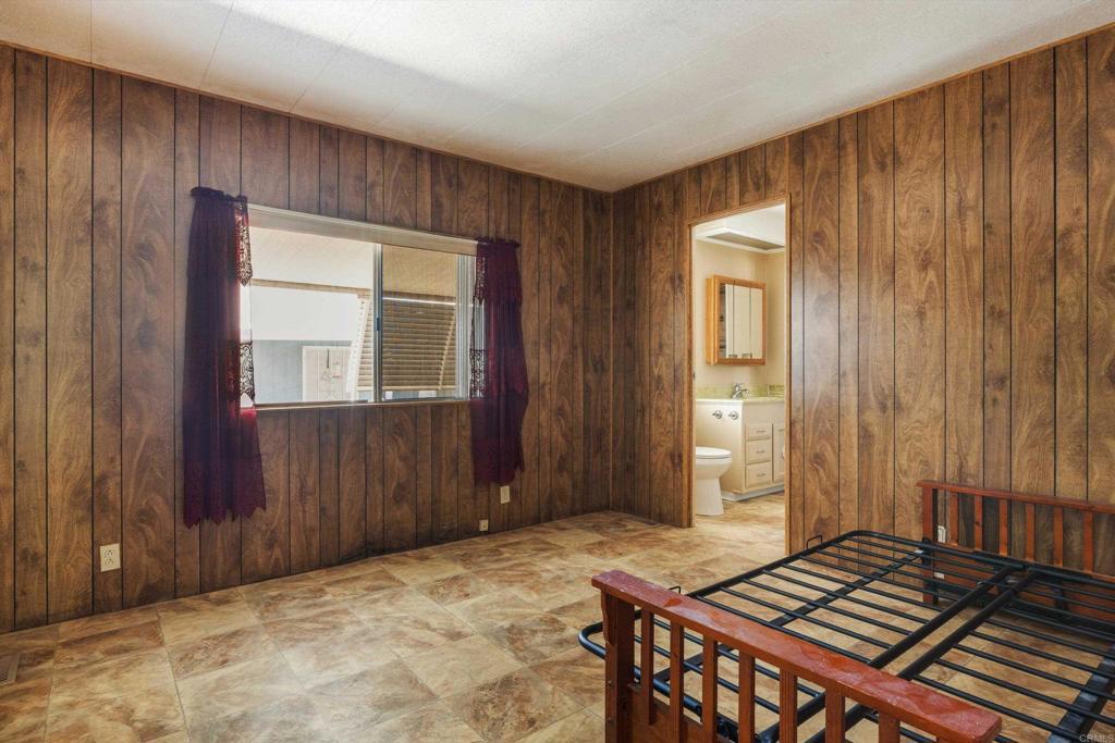 1175 La Moree Road, Unit 10 San Marcos, CA 92078 - Photo 25 of 40 a bedroom with a bed and wooden closet