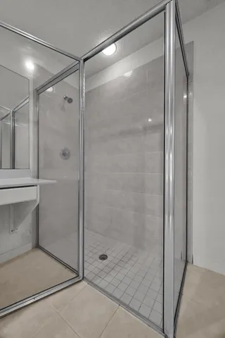 a bathroom with a glass shower door