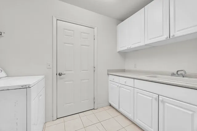 a kitchen with white cabinets