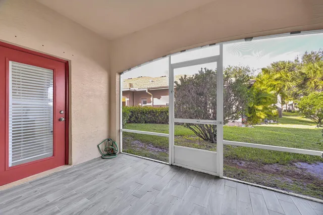 a view of backyard with window and wooden floor