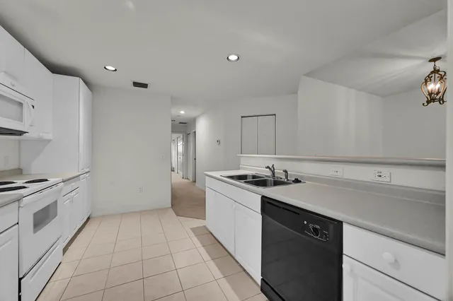 a kitchen with a sink and a stove top oven