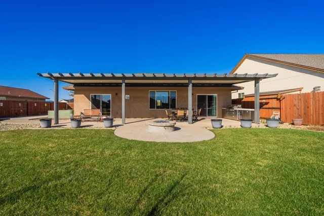 a view of a house with a backyard porch and sitting area