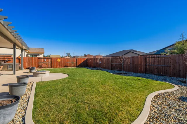 a view of a backyard with swimming pool
