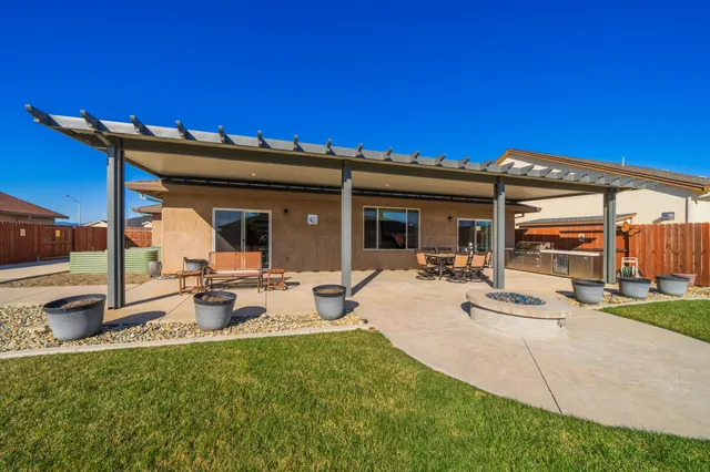 a view of a house with backyard sitting area and garden