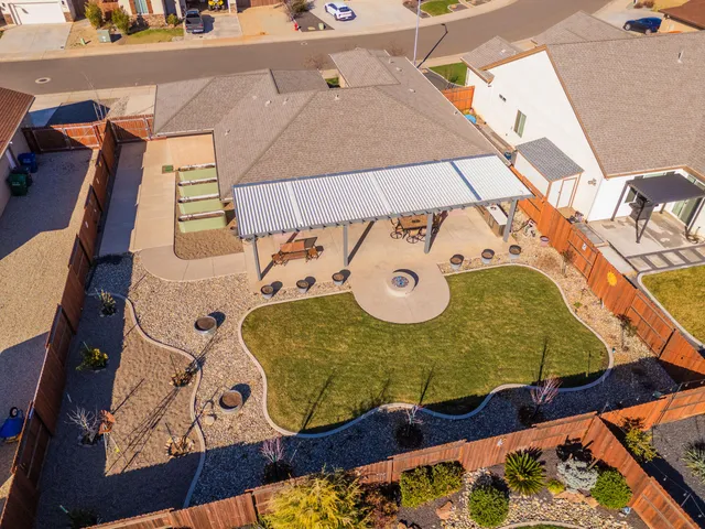 an aerial view of a house with garden space and street view