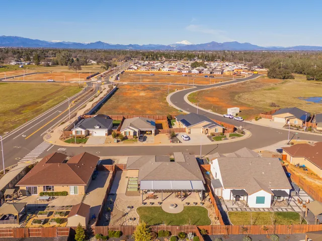 an aerial view of houses with yard