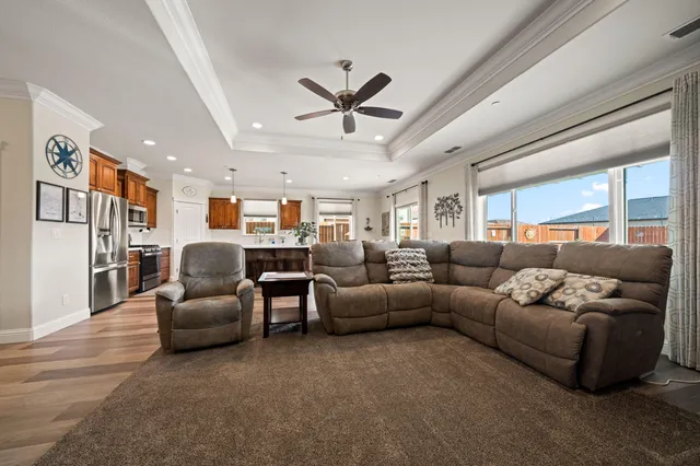 a living room with furniture and a ceiling fan