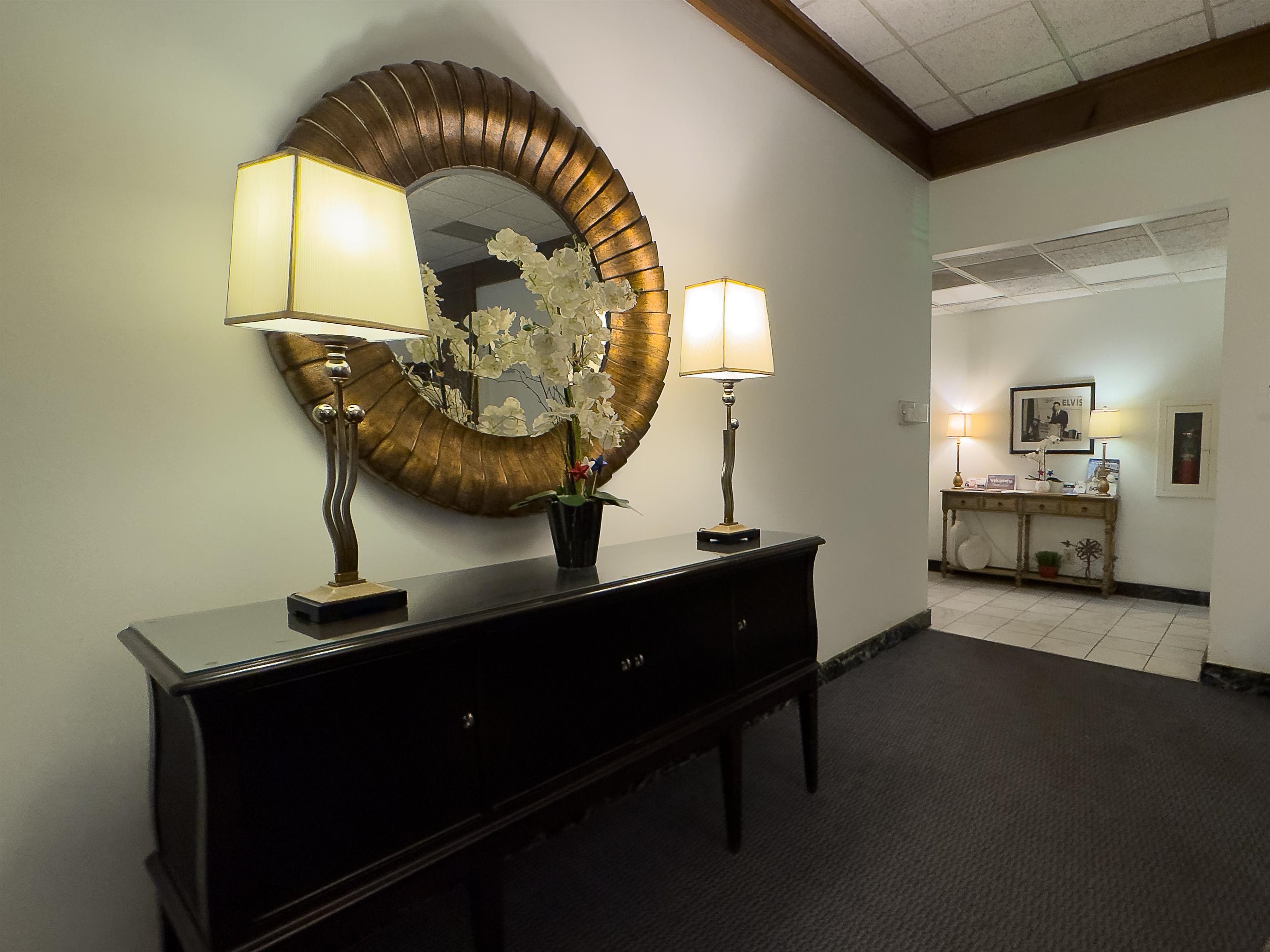 109 North Main Street, Unit 907 Memphis, TN 38103 - Photo 2 of 29 Entryway featuring a dark wood console table with a reflective surface, framed by a large circular decorative mirror