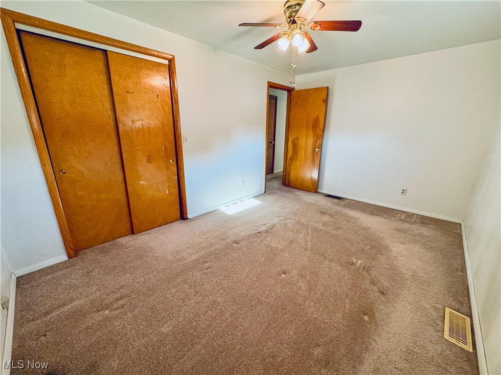 304 Stone Road Belpre, OH 45714 - Photo 6 of 34 Unfurnished bedroom with a closet, ceiling fan, and light colored carpet